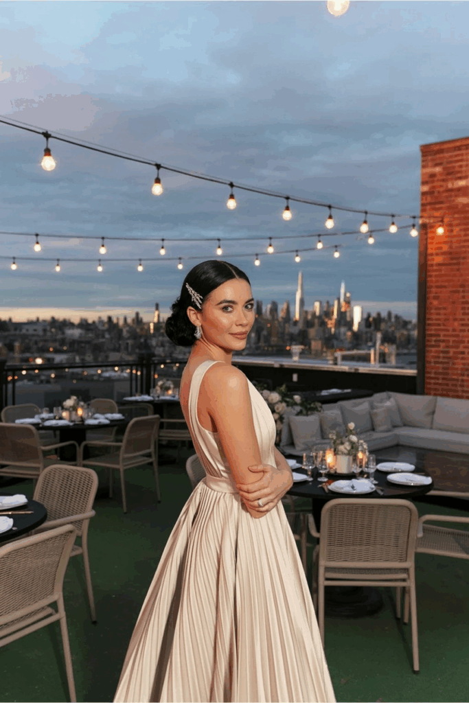 woman in a black tie A-line champagne gown with soft pleats