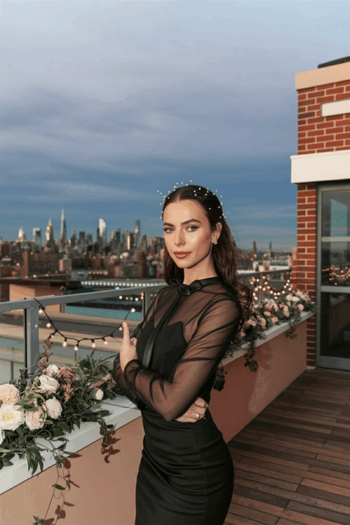 woman in a black tie dress with sheer long sleeves