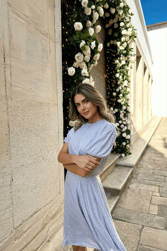 Woman in a pastel Tea-Length dress with short sleeves