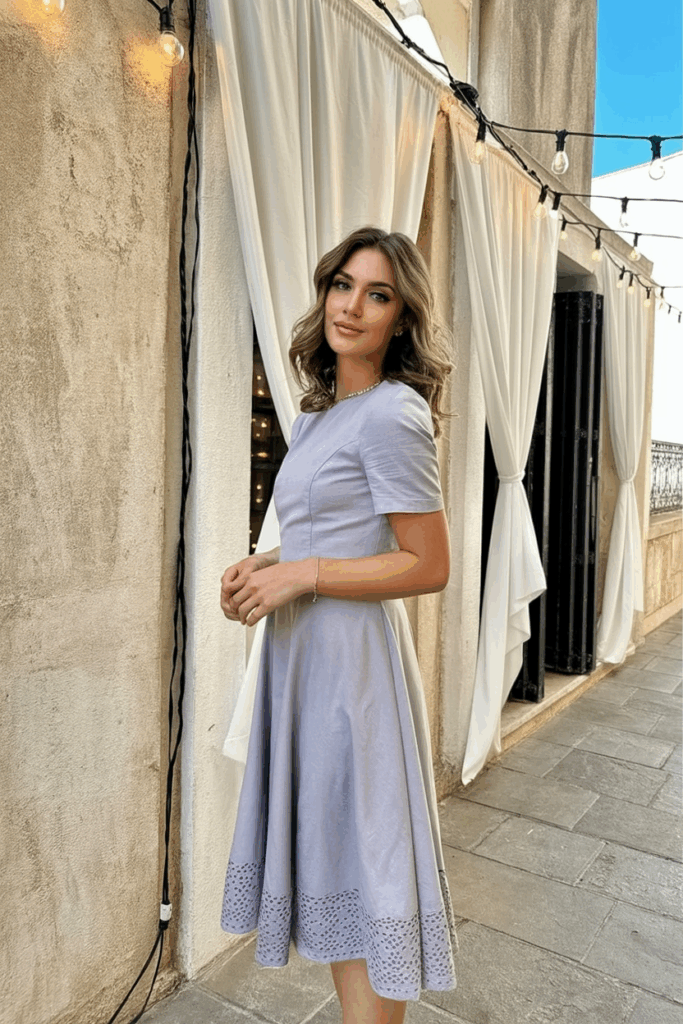 Woman in a pastel Tea-Length dress with short sleeves