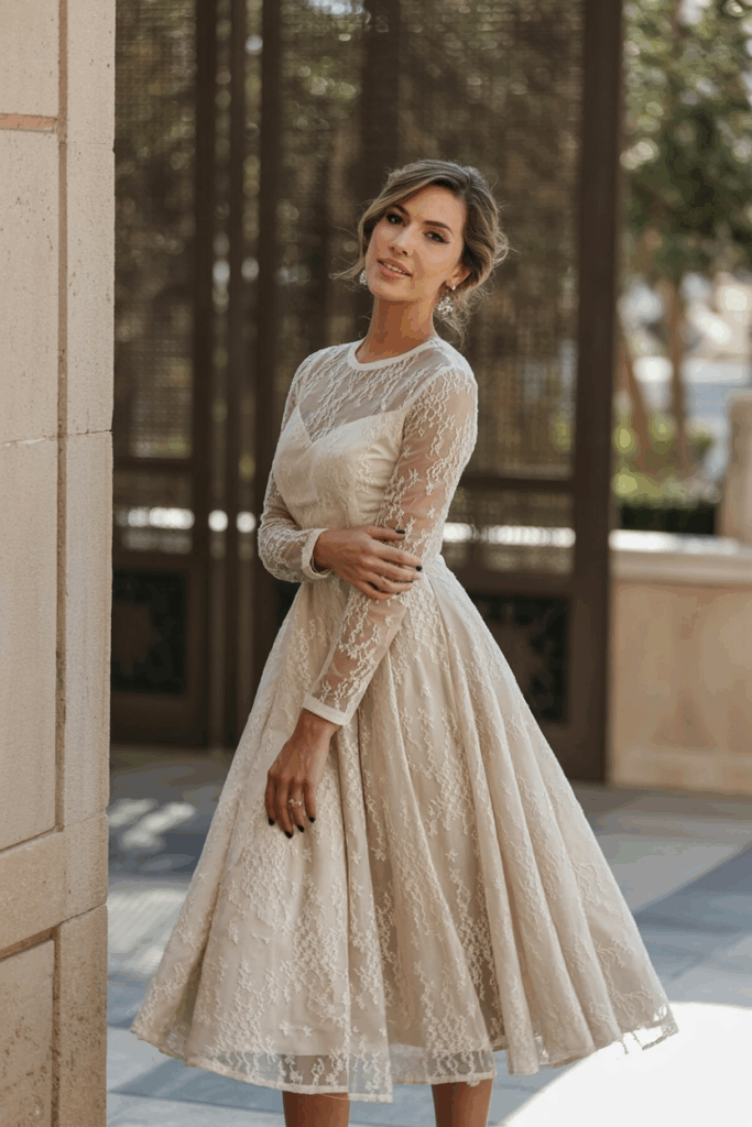 A woman wearing a classic A-line dress with full-length sleeves made of sheer lace