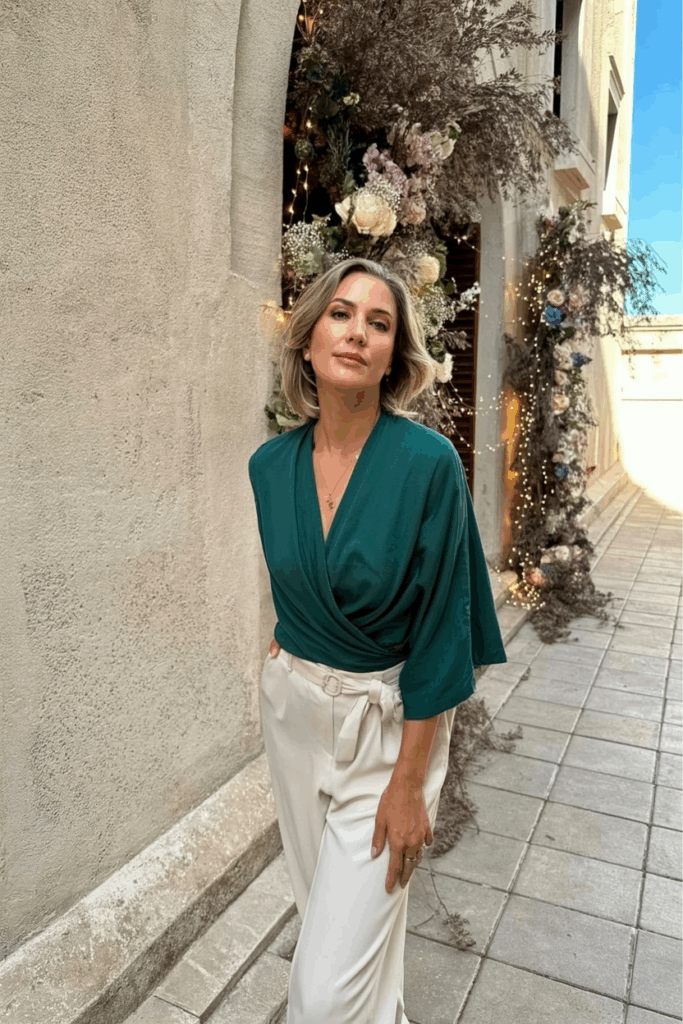 a woman in her 50s wearing a wrap dress