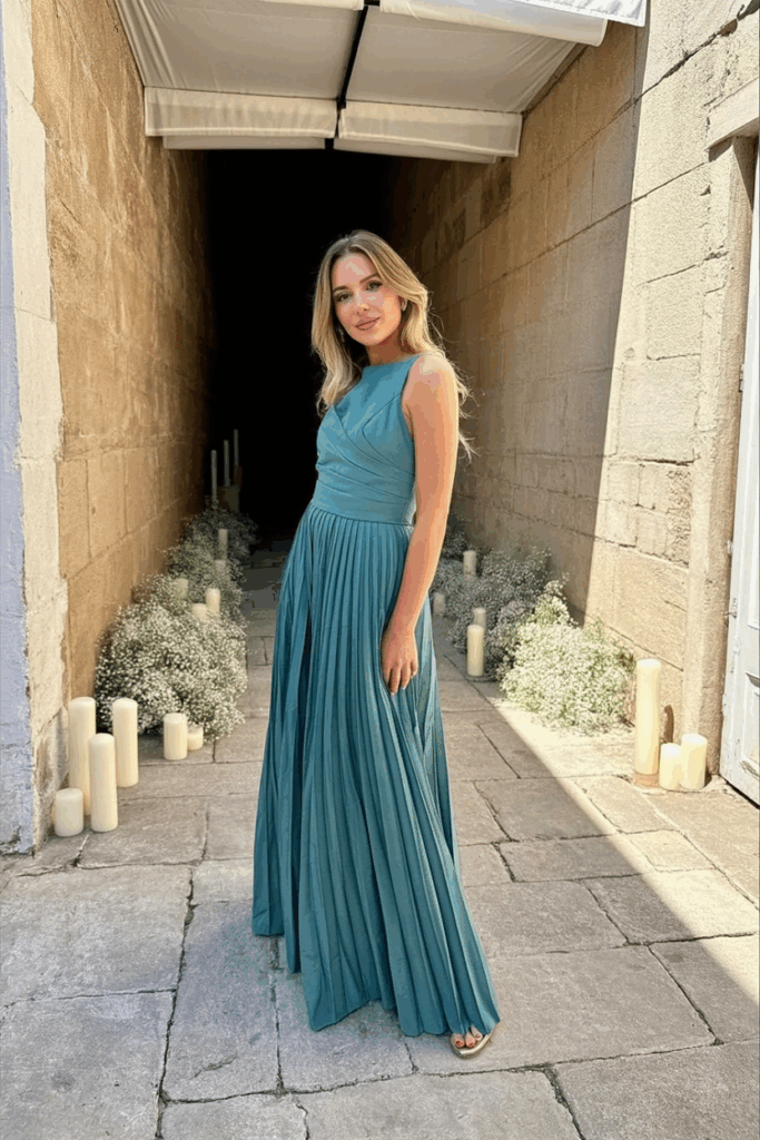 woman in a black tie A-line emerald gown with soft pleats