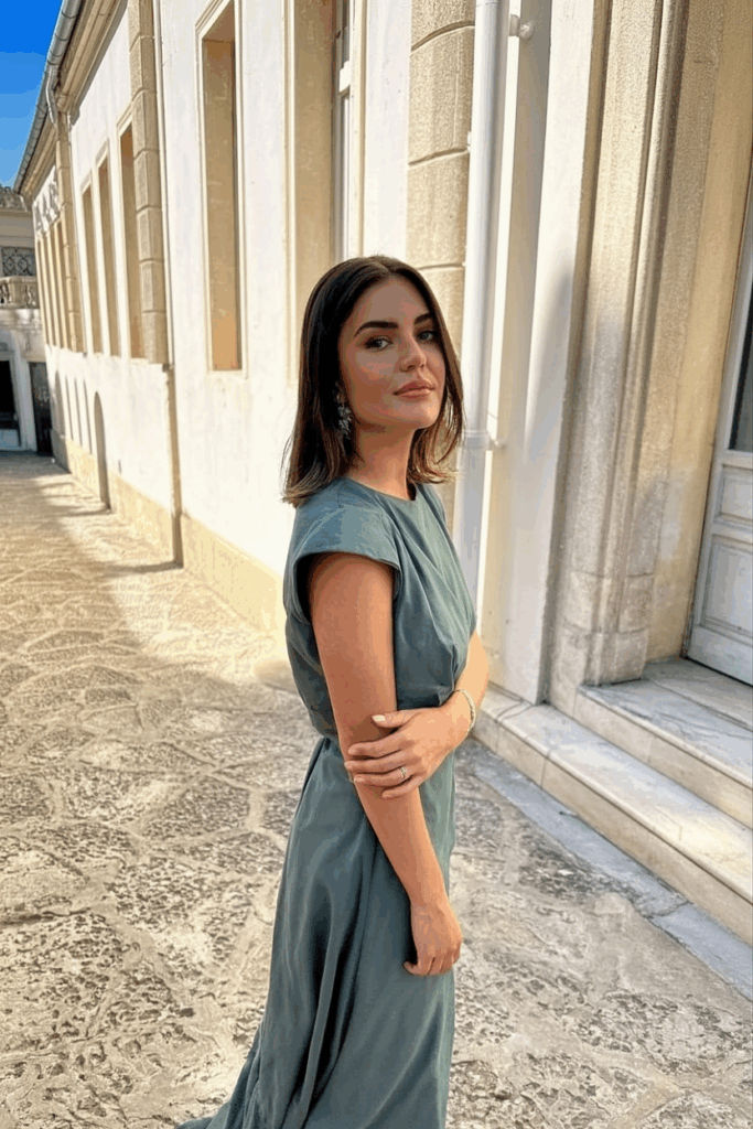 woman in A slate green gown with cap sleeves