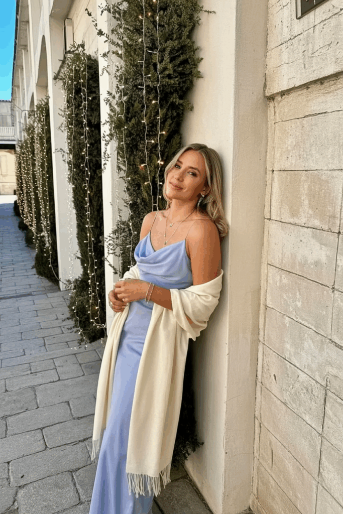 Woman in a soft lilac spaghetti strap dress with a light shawl
