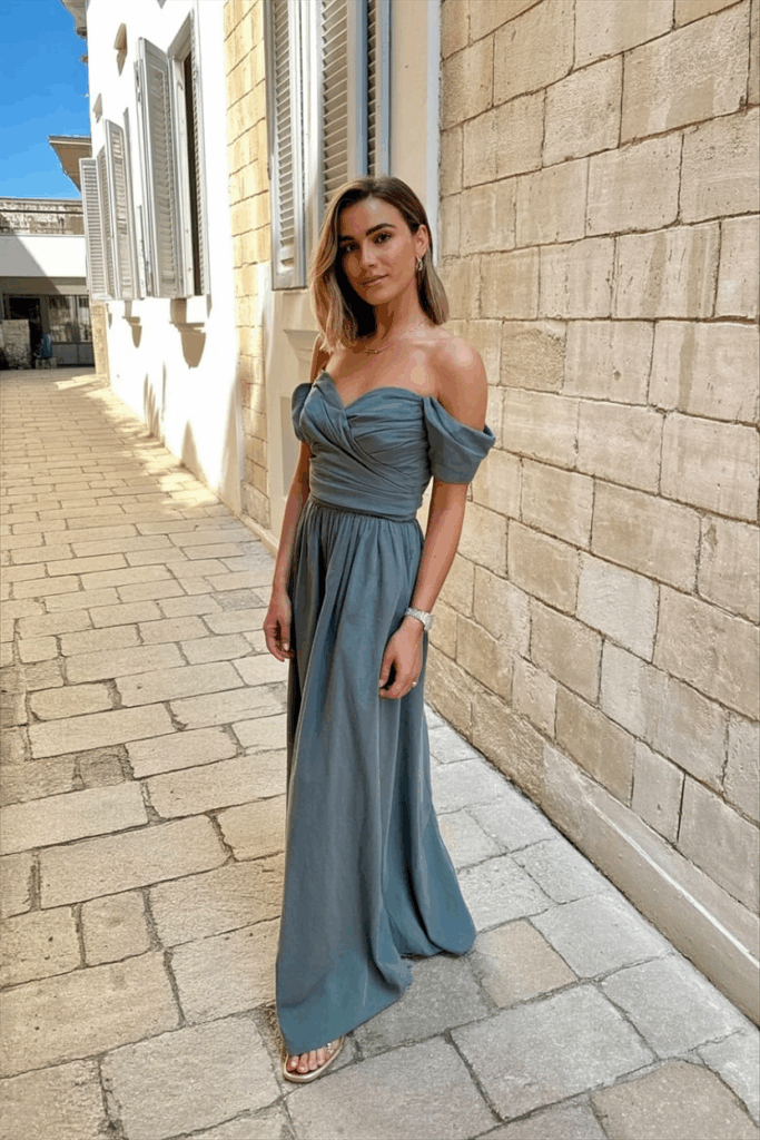 woman in a black tie off-the-shoulder gown