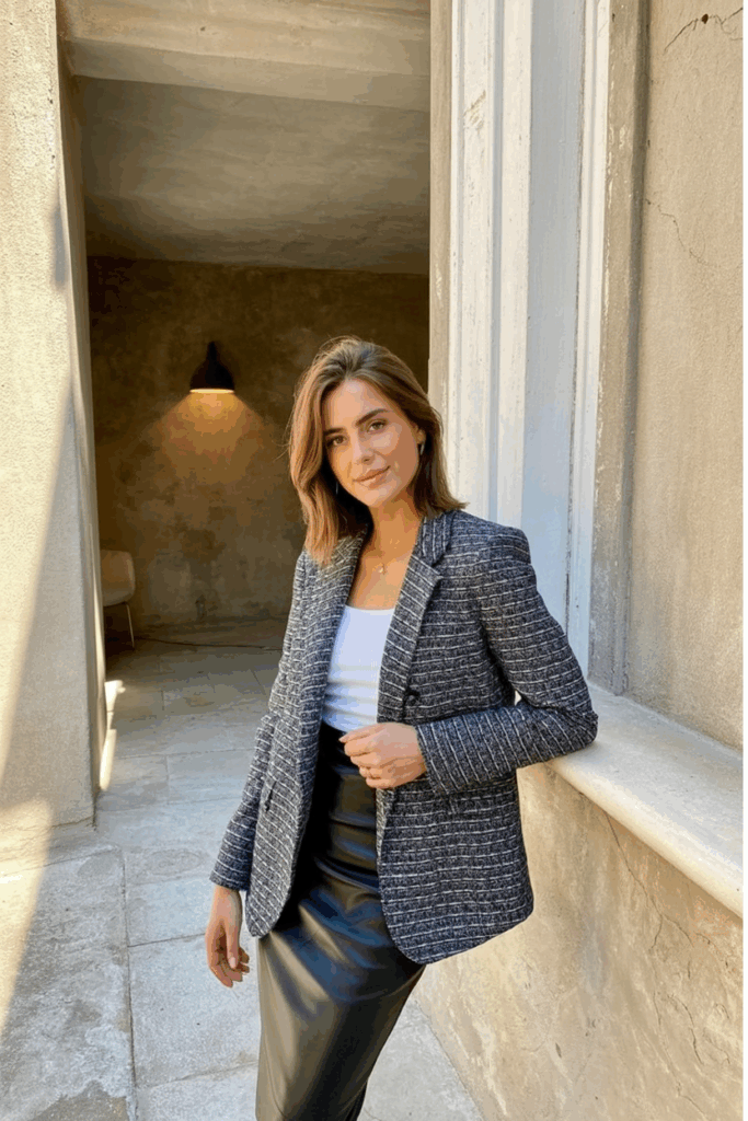 woman wearing a tailored tweed blazer over a pencil skirt
