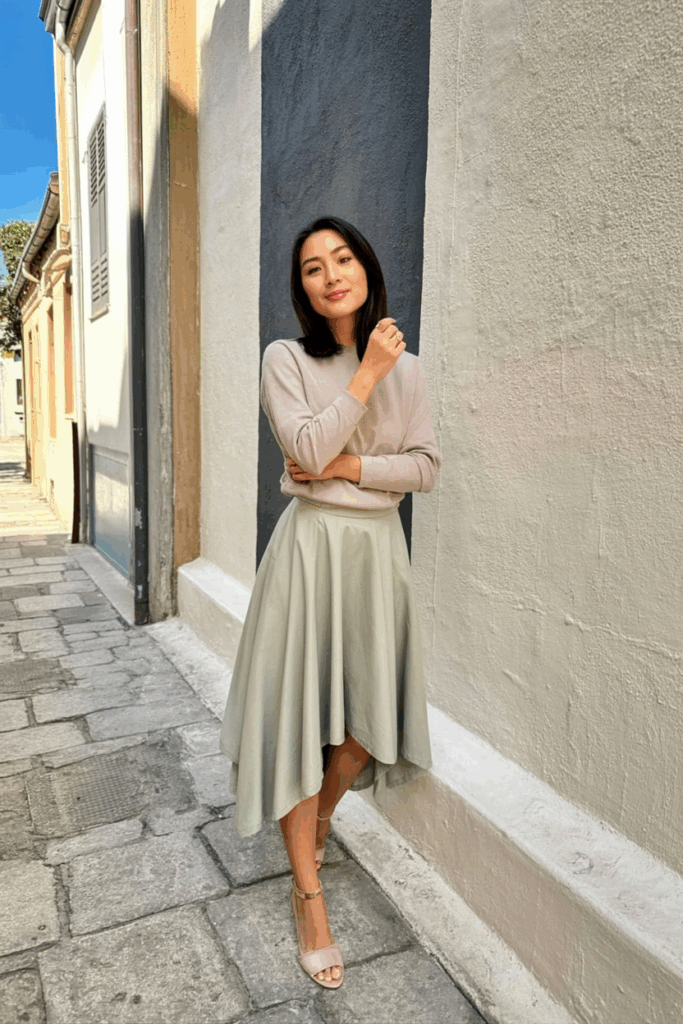 woman wearing a muted pastel midi skirt with an asymmetrical hem