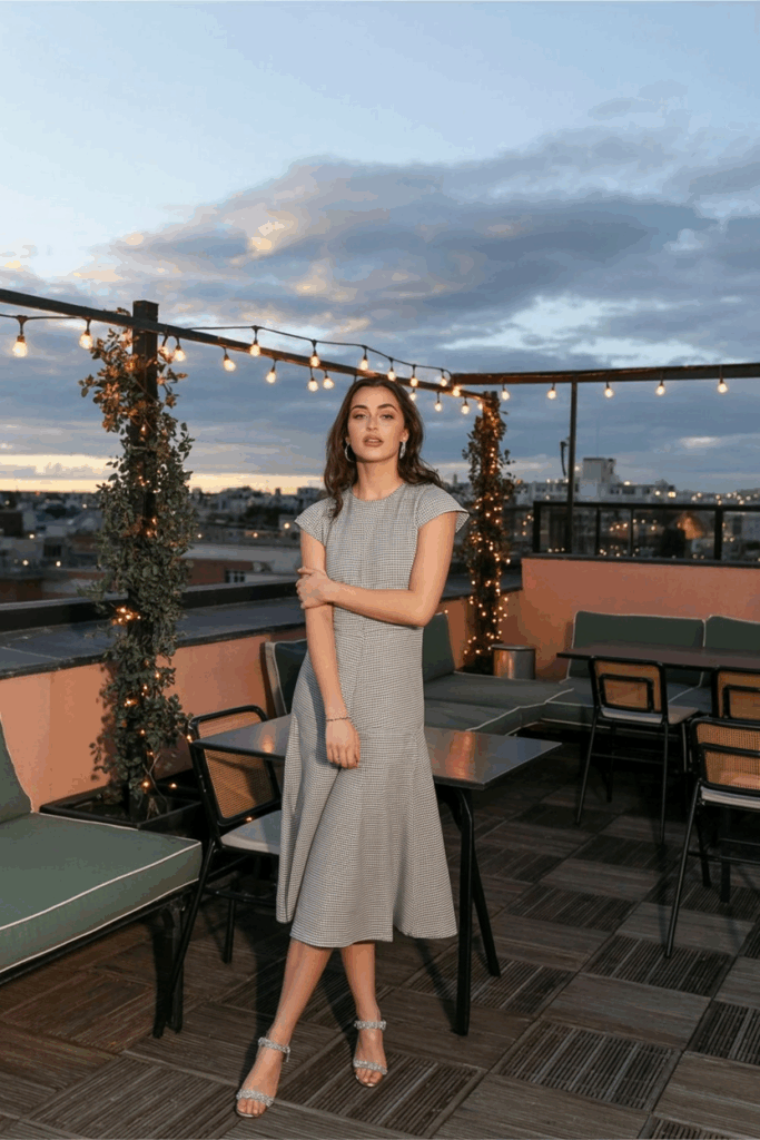 A woman in a beautifully tailored cap sleeved dress