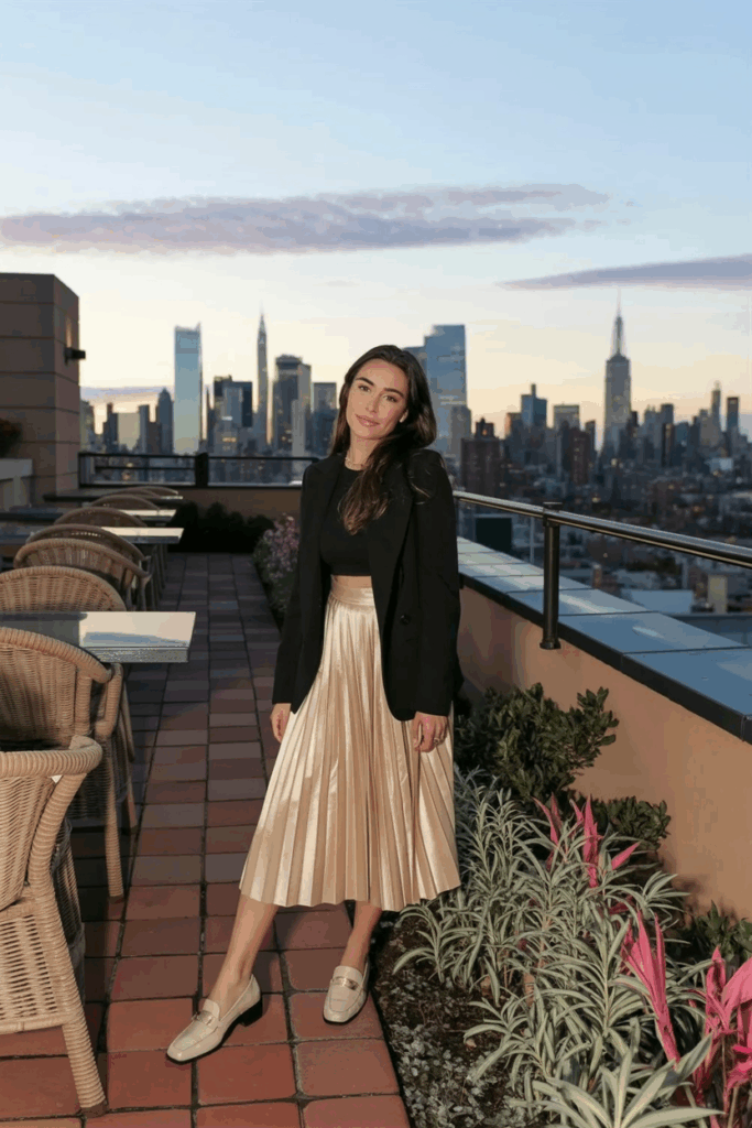 woman wearing beige leather loafers, pleated skirt