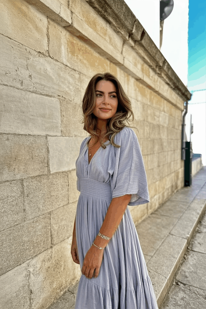 Woman wearing a soft lilac flowy maxi dress with light sleeve