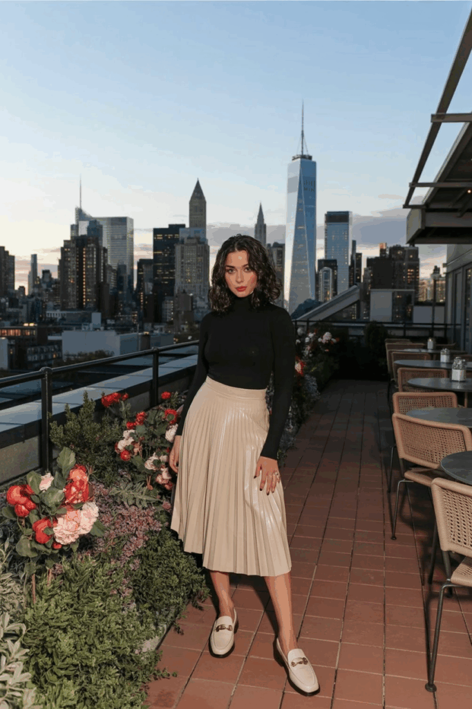 woman wearing beige leather loafers, pleated skirt