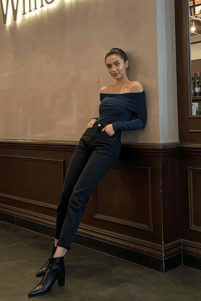 high-rise black jeans with an off-shoulder fitted top and pointed ankle boots