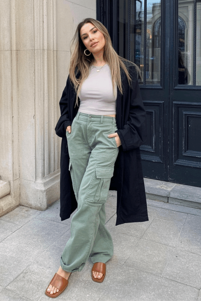 sage green cargo pants with a ribbed white tank, gold hoop earrings, and leather slide sandals
