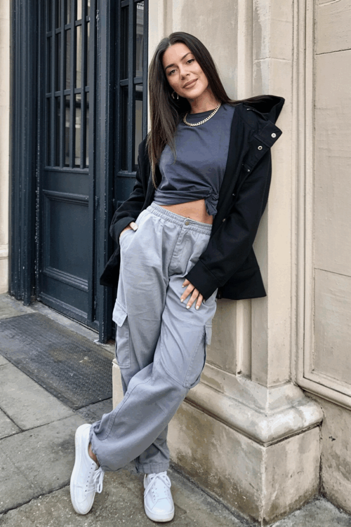 soft gray cargo pants, a slightly oversized navy boxy tee, a thin gold chain, and white sneakers